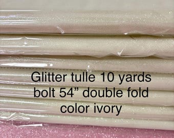 Ivory Tulle Gliter 54" double fold, color Ivory with unicorn glitter 10 yards per pack.