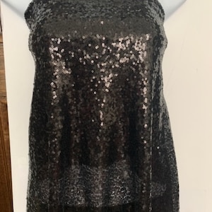 Black Sequins Mesh fabric width 56/57 inches sequins area 48 inches fabric has salvage mesh fabric on both side.