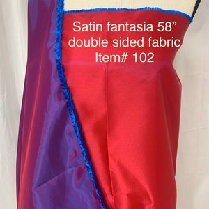 May include: Red and purple satin fabric with a blue trim. The fabric is double-sided and measures 58 inches. Item # 102. Satin fantasia.