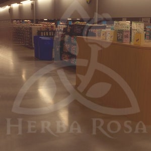 A full screen rendering of the Queen of Pentacles from the Liminal Space Tarot Deck. It shows a fully stocked wall in a grocery store, empty of people and dimly lit.  The label on the bottom reads Queen with a coin symbol on each side.