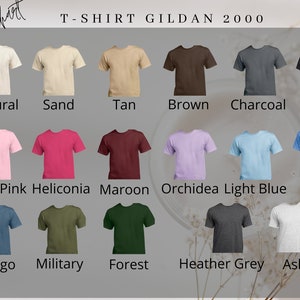 May include: A Gildan 2000 t-shirt color chart displaying seventeen short-sleeve shirts in various colors including natural, sand, tan, brown, charcoal, black, light pink, heliconia, maroon, orchidea, light blue, blue, indigo, military, forest, heather grey, and ash.