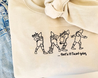 May include: A beige sweatshirt with a black graphic of four stick figures in a line. The figures are labeled "ooh", "aaah", "mhm", and "that's it I'm not going".