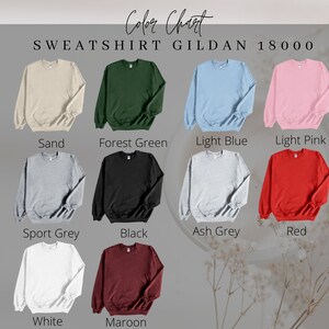 May include: Color chart for Gildan 18000 sweatshirts. The chart shows 12 different colors: Sand, Forest Green, Light Blue, Light Pink, Sport Grey, Black, Ash Grey, Red, White, and Maroon.