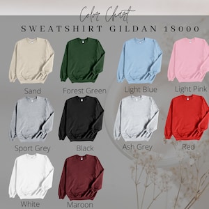 May include: Color chart for Gildan 18000 sweatshirts. The chart shows 12 different colors: Sand, Forest Green, Light Blue, Light Pink, Sport Grey, Black, Ash Grey, Red, White, and Maroon.