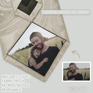 May include: Cream-colored paisley tie with a custom photo patch. The patch features a photo of a man and a child. The text "CUSTOM PHOTO TIE PATCH" is visible. The tie includes 3 sizes, a fabric patch, is removable, and no iron is needed.