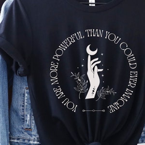 May include: Black t-shirt with a white graphic design of a hand holding a crescent moon. The text around the graphic reads "You are more powerful than you could ever imagine."