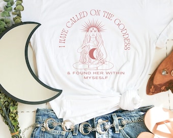 May include: White t-shirt with a pink graphic of a woman meditating with a crescent moon and the text "I have called on the goddess & found her within myself."