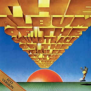 May include: Album cover art with the title "The Soundtrack of the Trailer of the Light" in large, 3D gold letters against a blue sky. A red sun is at the bottom, with a green field below. The words "Eco Version" are on a brown banner.
