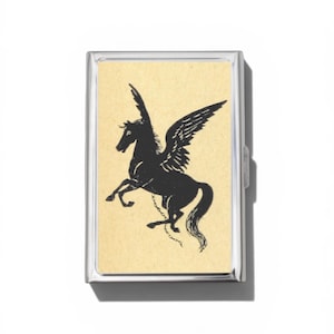May include: A rectangular silver-toned metal case featuring a centered cream-colored insert. The insert displays a black graphic illustration of a winged horse, or Pegasus, depicted in a rearing position with a thin chain attached to its front leg.