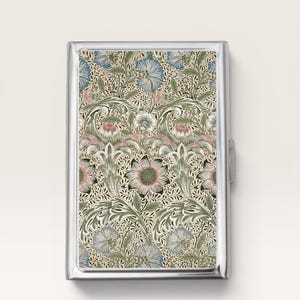 May include: A rectangular metal case featuring a polished silver frame and a decorative inlay with a dense botanical pattern. The design displays stylized flowers and foliage in shades of muted blue, soft pink, and sage green on a cream background.
