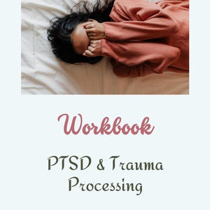 May include: A workbook titled "PTSD & Trauma Processing" with the word "Workbook" in a pink cursive font. The cover features a photo of a person lying on a bed with their face covered by their hands.