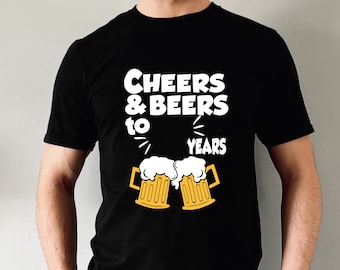 May include: Black t-shirt with white text that reads "Cheers & Beers to Years" and two yellow beer mugs with white foam.