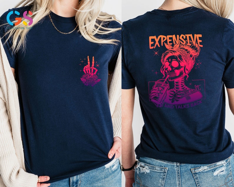 May include: A navy blue t-shirt with a pink and orange gradient design. The front of the shirt features a skeleton hand making a peace sign with a rose. The back of the shirt features a skeleton woman with a drink and the text "Expensive and Talks Back".