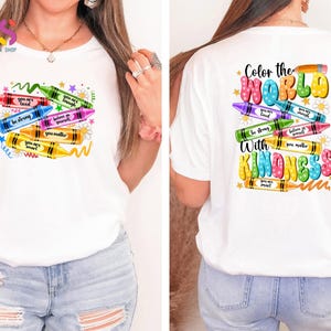 May include: White t-shirt with a colorful crayon design on the front and the text "Color the World with Kindness" on the back. The crayons have positive messages written on them, such as "You are loved", "Be strong", and "You matter".