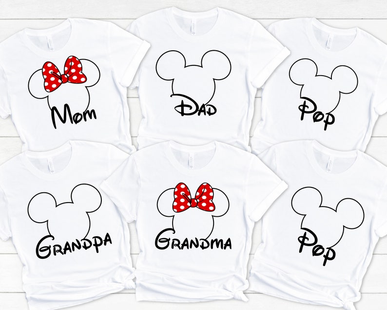 May include: Six white t-shirts with black Mickey Mouse ears and text. The shirts say "Mom", "Dad", "Pop", "Grandpa", "Grandma", and "Pop". One shirt has a red bow with white polka dots.