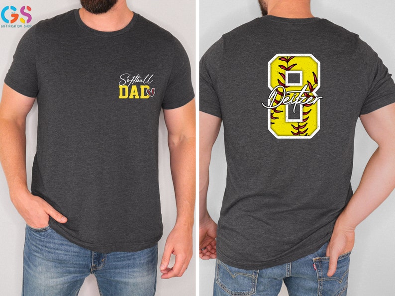 May include: A dark grey t-shirt with the text "Softball Dad" and a heart on the front. The back of the shirt has a white number 8 with a yellow softball inside and the text "Dexter" underneath.
