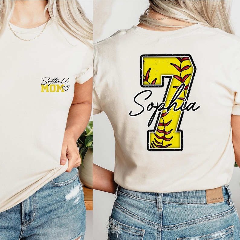 May include: A white t-shirt with the text "Softball Mom" on the front and a yellow softball with the number 7 and the name "Sophia" on the back.