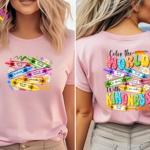 May include: Pink t-shirt with a design of colorful crayons with positive messages like "You are loved", "You are enough", "Be strong", "Believe in yourself", "You matter", and "You are smart". The back of the shirt has the text "Color the World with Kindness" with a similar crayon design.