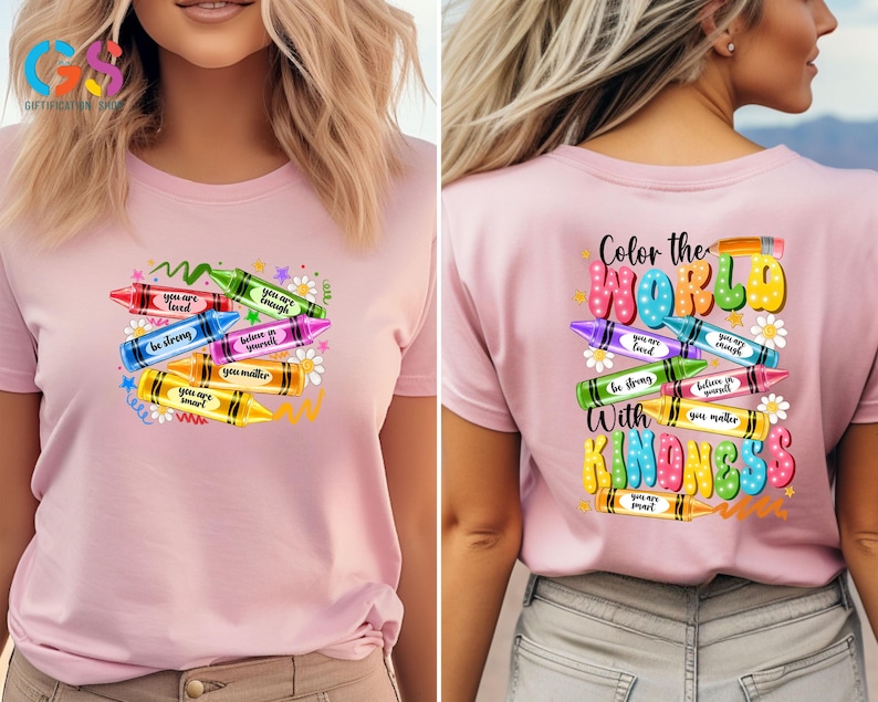 May include: Pink t-shirt with a design of colorful crayons with positive messages like "You are loved", "You are enough", "Be strong", "Believe in yourself", "You matter", and "You are smart". The back of the shirt has the text "Color the World with Kindness" with a similar crayon design.