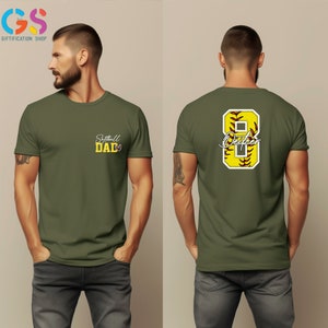May include: A green t-shirt with the text "Softball Dad" on the front and a yellow softball with the number 8 and the text "Dad" on the back.