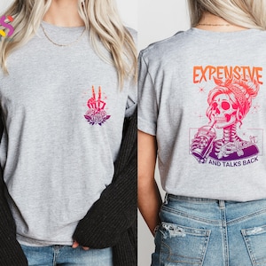 May include: Gray t-shirt with a skeleton graphic on the front and a skeleton graphic with the text "Expensive, Difficult and Talks Back" on the back.