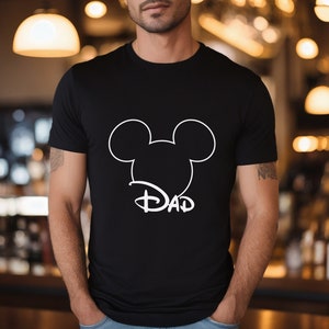 May include: Black t-shirt with a white outline of Mickey Mouse ears and the word "DAD" underneath.
