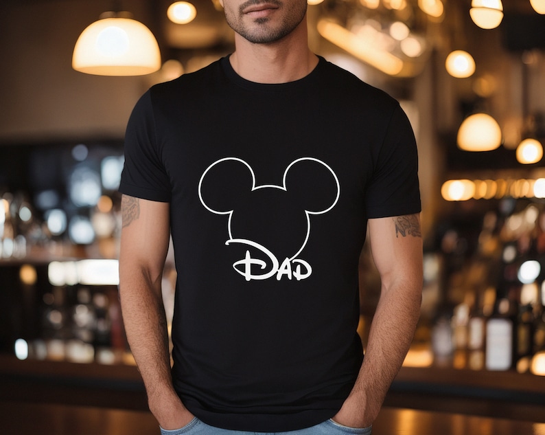 May include: Black t-shirt with a white outline of Mickey Mouse ears and the word "DAD" underneath.