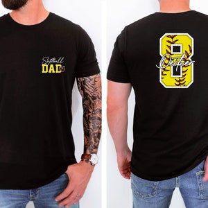 May include: Black t-shirt with the text "Softball Dad" on the front and a yellow softball with the number 8 and the name "Dexter" on the back.
