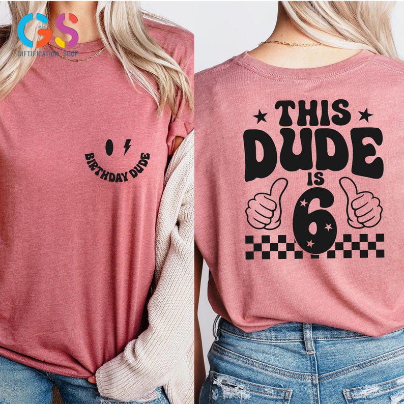 May include: Pink t-shirt with a black smiley face and the text "Birthday Dude" on the front and the text "This Dude is 6" with a black number 6 and two thumbs up on the back.