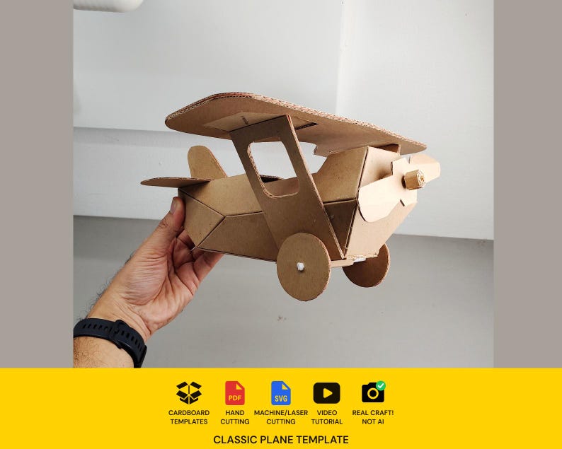 May include: A brown cardboard biplane model featuring a propeller, two wings, and circular wheels. The base of the image includes text: CARDBOARD TEMPLATES, PDF, SVG, MACHINE/LASER CUTTING, VIDEO TUTORIAL, REAL CRAFT! NOT AI, CLASSIC PLANE TEMPLATE.