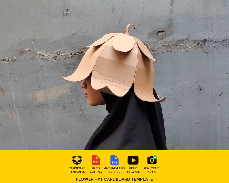 May include: A tan cardboard flower hat featuring layered petal-shaped panels and a small stem at the top. The bottom yellow banner displays icons for cardboard templates, PDF, SVG, video tutorial, and real craft, with text reading FLOWER HAT CARDBOARD TEMPLATE.