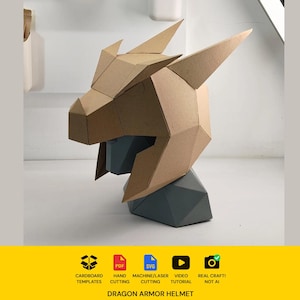 May include: A geometric dragon armor helmet constructed from tan cardboard, featuring sharp angular horns and a faceted design. Below the helmet, a dark gray geometric bust stand is visible. Text includes: Cardboard Templates, PDF, SVG, Hand Cutting, Machine/Laser Cutting, Video Tutorial, Real Craft! Not AI, Dragon Armor Helmet.