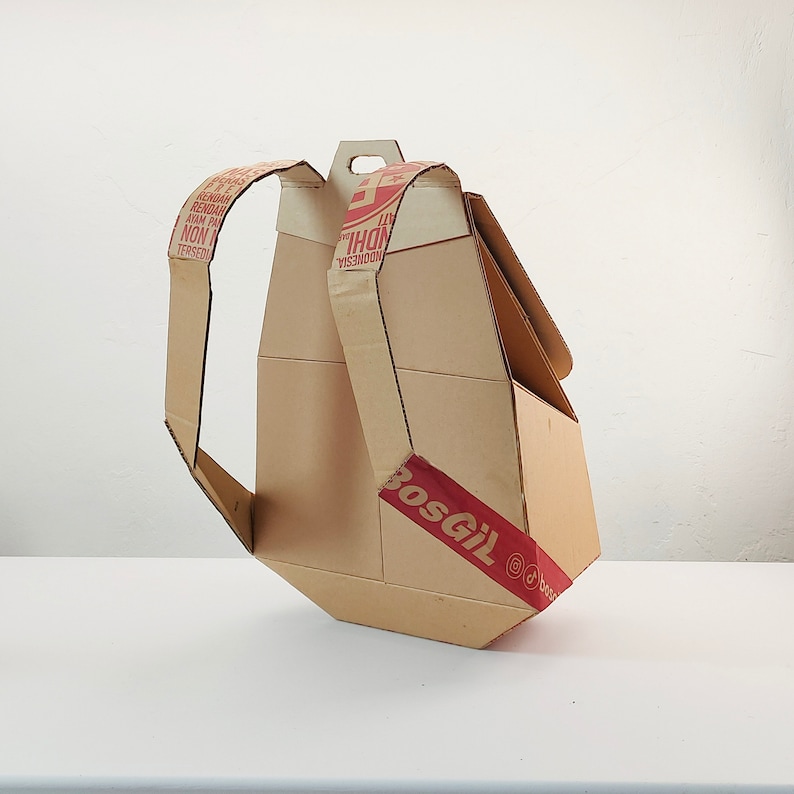 May include: A cardboard backpack with red and white text that reads "INDONESIA" and "BOSGIL".