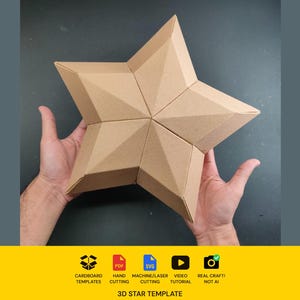 May include: A five-pointed star made of light brown cardboard with a geometric, faceted surface. The star features sharp, folded edges and a symmetrical design. Below the star, text reads: Cardboard Templates, Hand Cutting, Machine/Laser Cutting, Video Tutorial, Real Craft! Not AI, 3D Star Template.