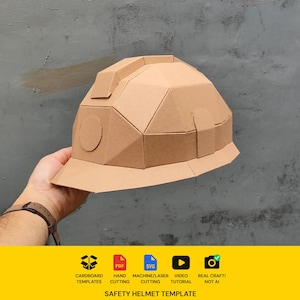 May include: A geometric safety helmet constructed from light brown cardboard, featuring a faceted dome design, a front brim, and a circular side detail. The base includes icons for cardboard templates, PDF, SVG, video tutorial, and real craft.