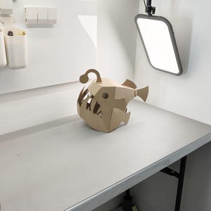 Cardboard Angler Fish Full Head Mask on the table