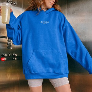 May include: A royal blue oversized hoodie with a white embroidered logo that says "Jeremiah 29:11".