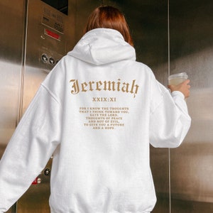 May include: White hooded sweatshirt with the text "Jeremiah XXIX:XI" and a bible verse printed on the back in brown.