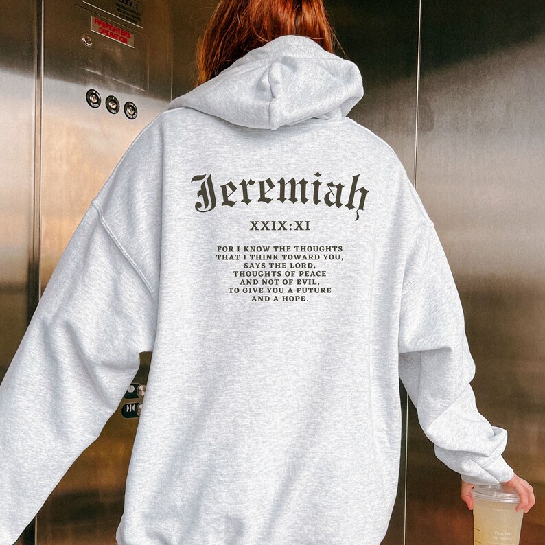 May include: Gray hooded sweatshirt with the text "Jeremiah XXIX:XI" and a bible verse printed on the back.