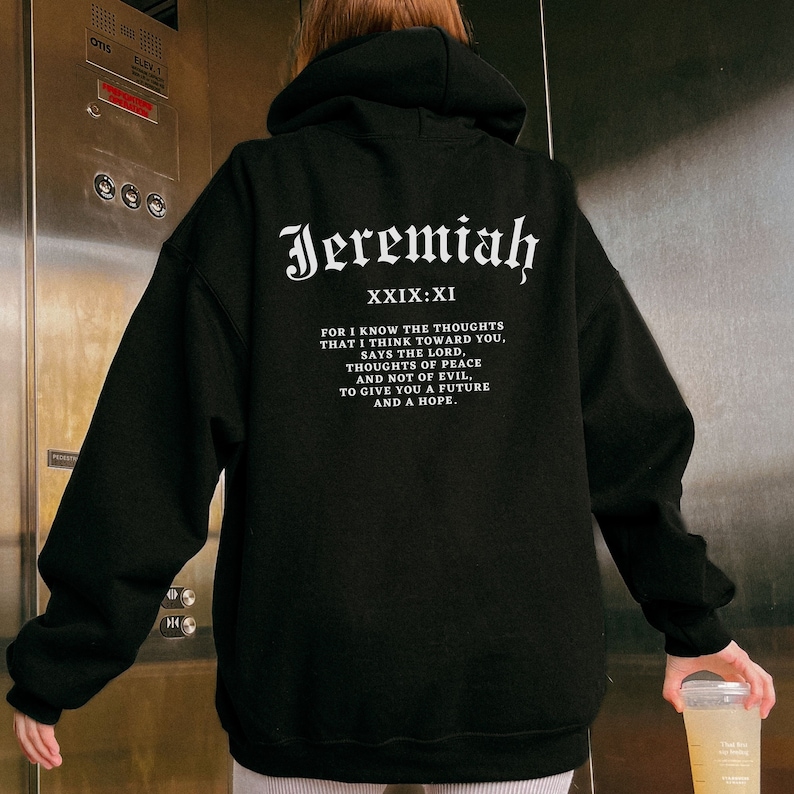 May include: Black hooded sweatshirt with white text that reads "Jeremiah XXIX:XI" and a quote from the Bible. The quote reads "For I know the thoughts that I think toward you, says the Lord, thoughts of peace and not of evil, to give you a future and a hope."