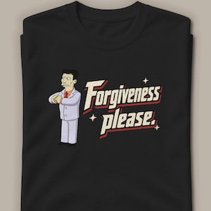 Op de afbeelding: Een zwart t-shirt met ronde hals voorzien van een cartoonillustratie van een persoon in een lichtgekleurd pak met een oranje das, gevouwen handen en de tekst "Forgiveness please." in een crèmekleurig lettertype met rode schaduw.