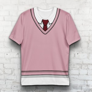 May include: Pink short-sleeved t-shirt with a white collar and a black and gray v-neck design. A red tie is visible in the center of the v-neck.