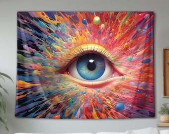 May include: A rectangular wall tapestry featuring a central human eye with a bright blue iris and long dark eyelashes. The eye is surrounded by a vibrant, explosive burst of multicoloured paint splatters, including shades of red, yellow, and purple.