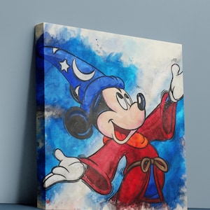 May include: Canvas art print featuring Mickey Mouse in a sorcerer's outfit. Mickey is depicted with a blue wizard hat with stars and a crescent moon, a red robe, and white gloves. The background has blue and white watercolor effects.