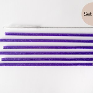 May include: Set of six purple glitter reusable drinking straws with a cleaning brush. Set of 6.