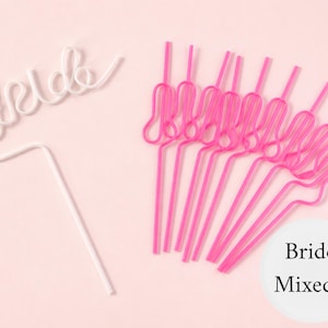 May include: A collection of pink and white decorative straws. One white straw spells out "bride" in cursive. The other straws are pink and have a looped design. The straws are on a light pink background. A white circle with the words "Bride Mixed 1" is in the lower right corner.