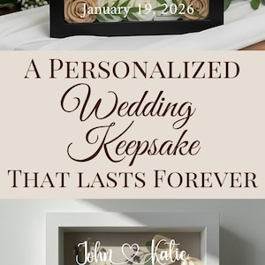 May include: Personalized wedding keepsake shadow boxes. The black box features the text "The Smith's", initials "A&M", and the date "January 19, 2026". The white box has the names "John & Katie" and the date "May 15, 2025". Both boxes are decorated with flowers.