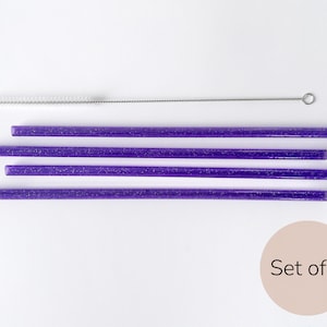 May include: Set of four purple glitter reusable drinking straws with a cleaning brush. Set of 4.