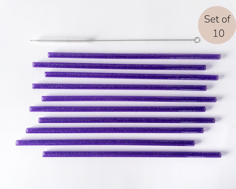 May include: Set of 10 purple glitter reusable drinking straws with a cleaning brush.