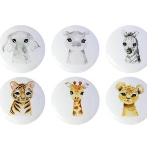 May include: Six round white ceramic knobs with different animal illustrations. The animals are an elephant, a hippopotamus, a zebra, a tiger, a giraffe, and a lion. The animals are all facing forward and have a cartoonish style.